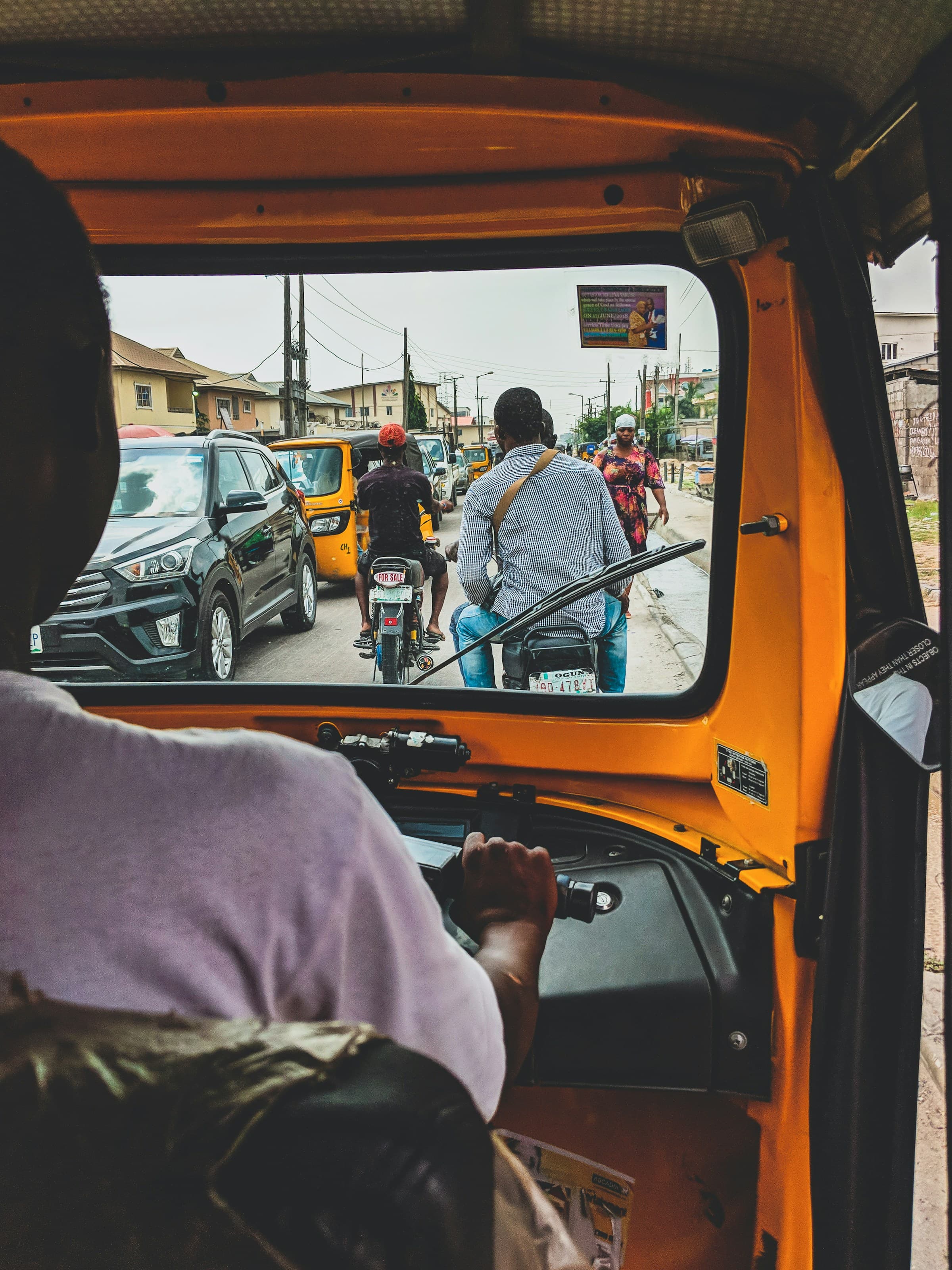 Yellow and black vehicle on a Lagos road