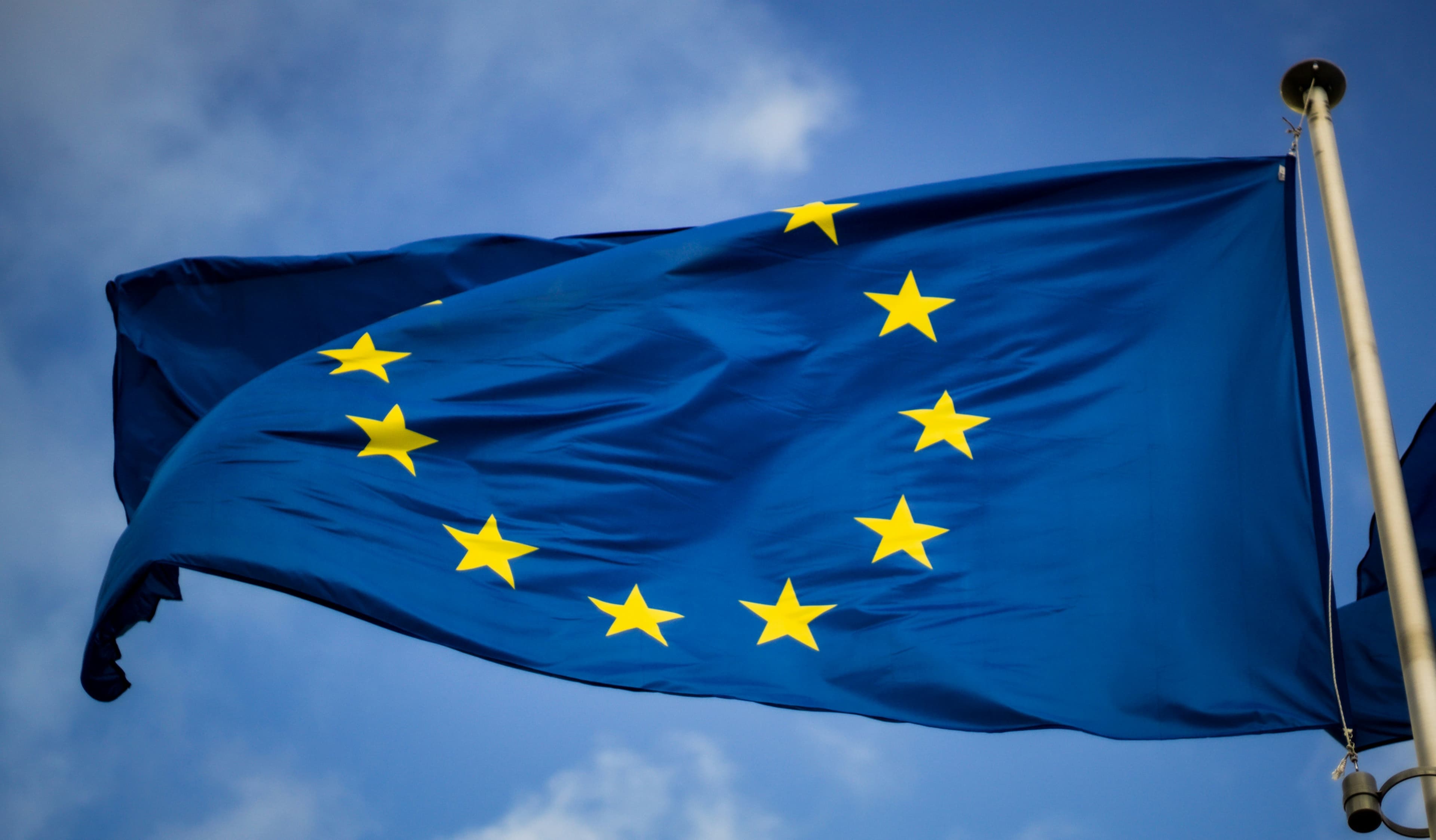 European Union flag flying against a cloudy sky