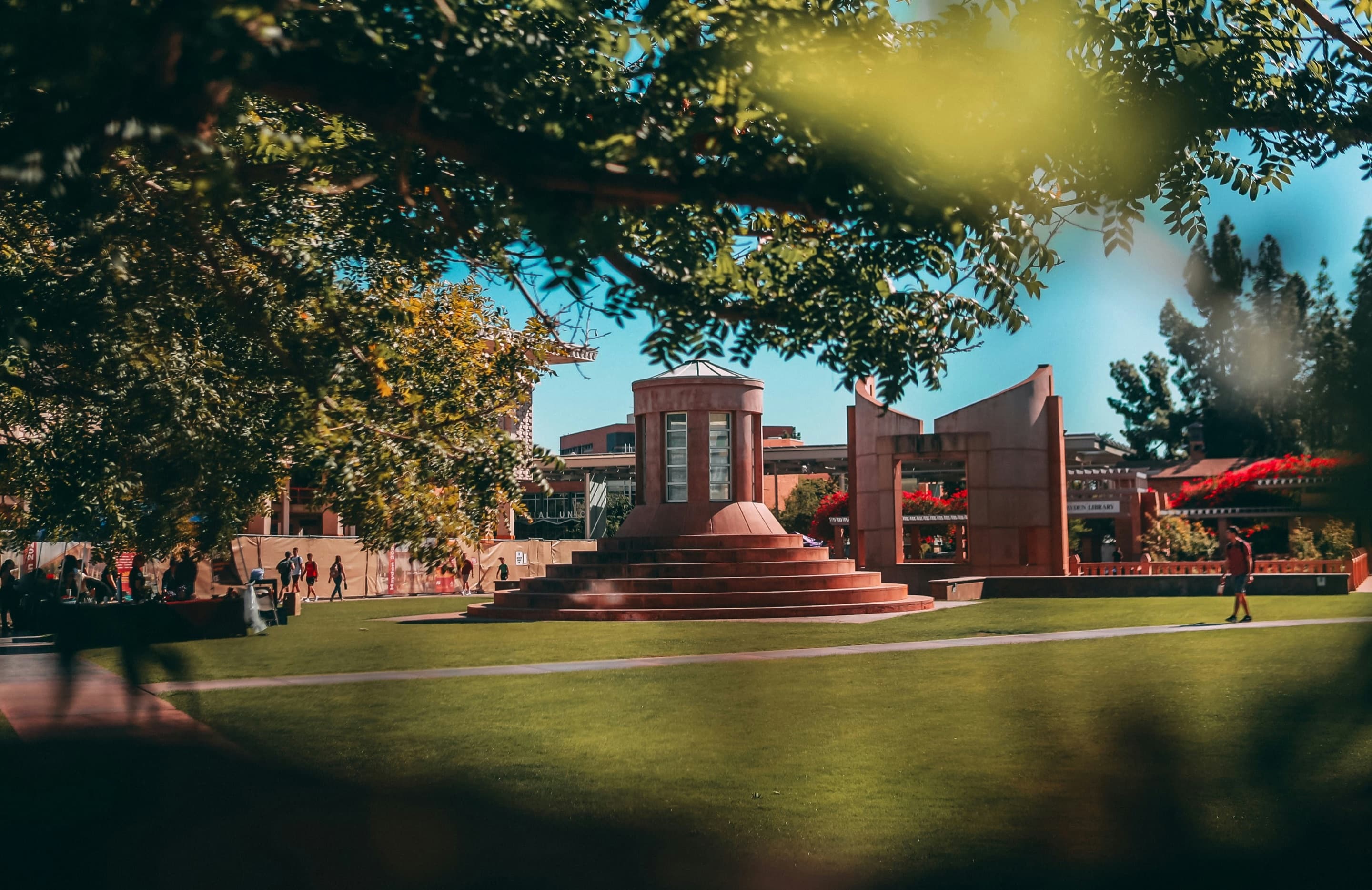 Modern university building framed by autumn trees